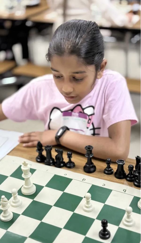 Children learning and playing chess
